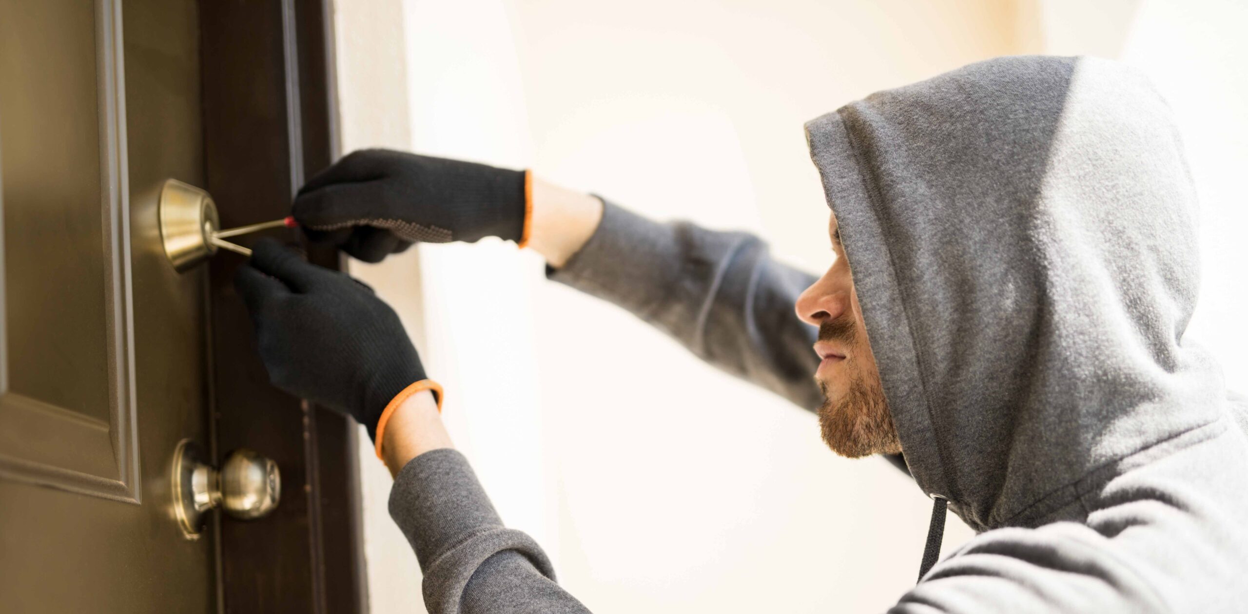 Burglar picking lock of a house