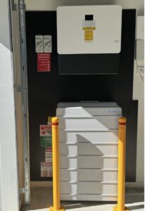 Maudsland Gold Coast home garage installation of a Sungrow solar battery stack, completed after a solar performance and battery readiness assessment to help reduce high electricity bills from heavy household energy usage. Integrated with iSolarCloud App for real-time monitoring, energy savings, and reduced grid dependency.