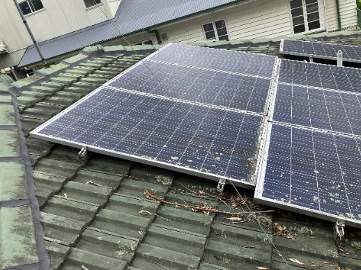 Dirty solar panels before cleaning at a property in Indooroopilly