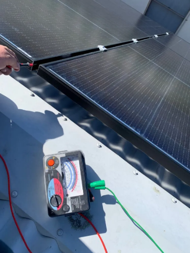 Electrical test on a solar panel array using an analog insulation resistance tester at a property in Mount Gravatt