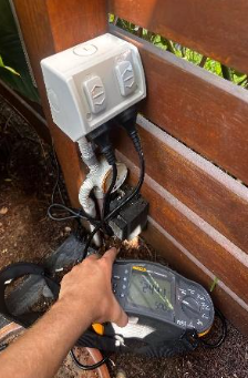 Electrical testing with multifunction electrical tester on outdoor electrical outlet at a property in broadbeach.