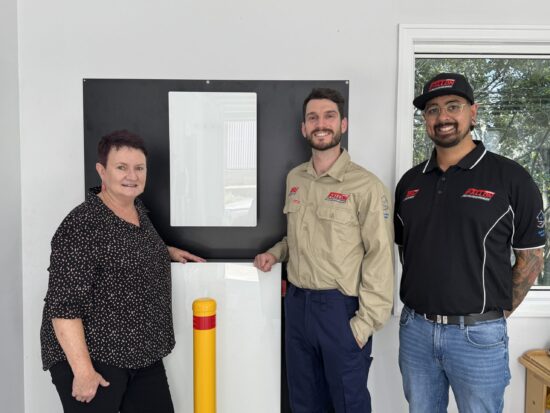 An image of the customer, Shayne with her newly installed solar battery and two Fallons employees.