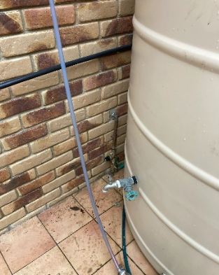 Water line connection found behind water tank at a property in Mt Gravatt.