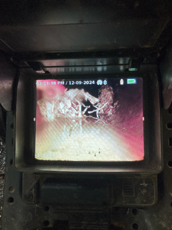 An image showing the cctv footage captured inside a sewer pipe in West End, showing tree root obstructions causing blockages.