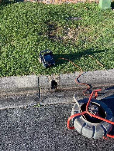 cctv drain inspection being performed through a curb access point at a property in albany creek