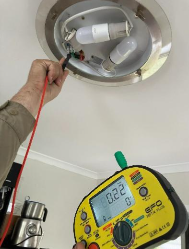 electrical testing being performed on a ceiling light with a multifunction electrical tester at a property in ipswich