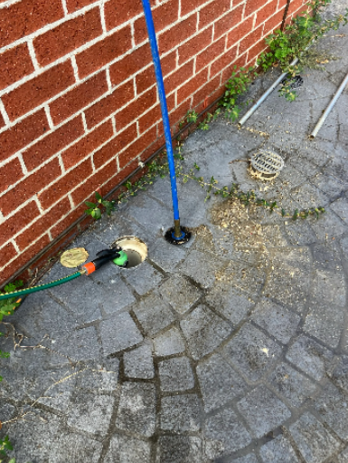 Unblocking a kitchen drain in Forest Lake using professional drain plumbing tools.