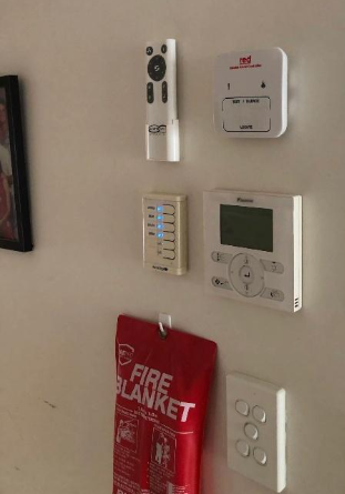 A smoke alarm wall controller installed to assist in controlling smoke alarms.