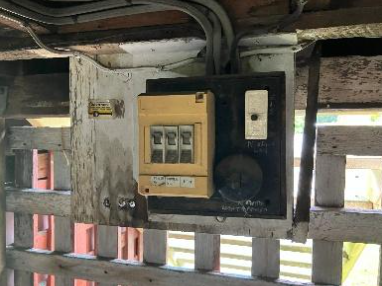An image of a very old, non compliant switchboard with improper earthing in Ashgrove.