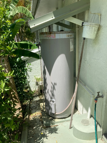 old rusty hot water system to be replaced at a property in caloundra