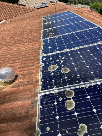 Old, damaged solar panels on a rooftop in Capalaba.
