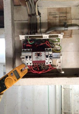 An image of an old, non compliant switchboard found at a property in West End.