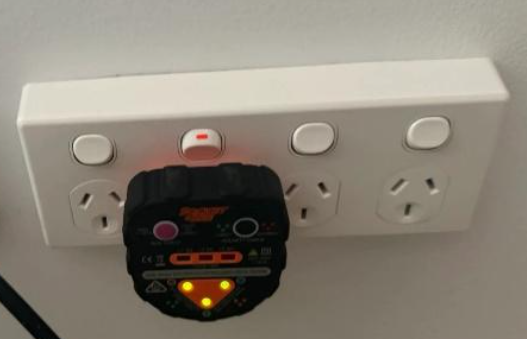 An image of powerpoint/outlet testing being performed at a household in Noosa during an electrical upgrade.