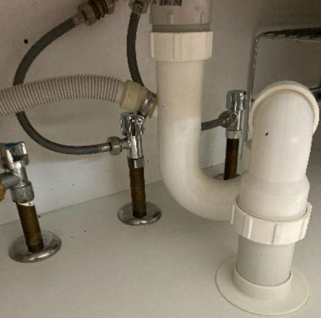 worn out basin flick mixers under the sink at a property in ashgrove