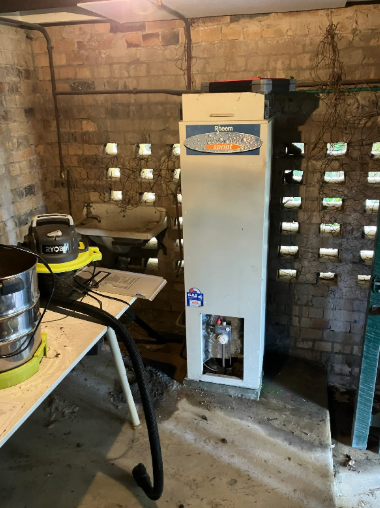 Old rheem hot water system to be replaced at a property in Hamilton