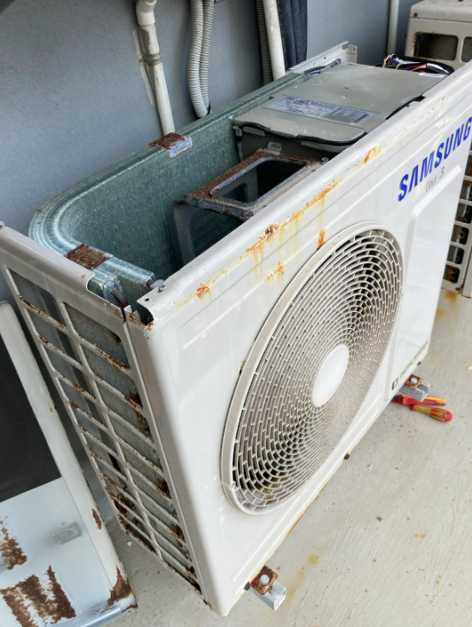 corroded outdoor air conditioning unit to be replaced at a property in Palm Beach