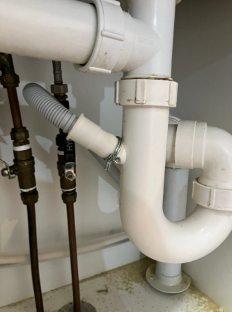 piping and drain lines for a dishwasher at a property in Ashgrove